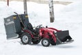 Wheel tractor with water tank for pouring ice stands in the snow