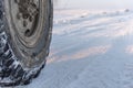 Wheel of a truck on snow-covered road, close up, copy space Royalty Free Stock Photo