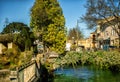 Wheel of water mill in Medieval village L`Isle-sur-Sorgue, Vaucluse, Provence, France. Famous Sorgue river with green water and Royalty Free Stock Photo