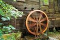 The wheel of the windmill is spinning and running water. An old water mill. Royalty Free Stock Photo