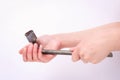 Wheel wrench in hand of the girl. Symbol of hard work, feminism and labor day. Isolate on white background Royalty Free Stock Photo