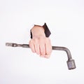 Wheel wrench in hand of the girl. Symbol of hard work, feminism and labor day. Isolate on white background Royalty Free Stock Photo