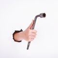 Wheel wrench in hand of the girl. Symbol of hard work, feminism and labor day. Isolate on white background Royalty Free Stock Photo