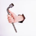 Wheel wrench in hand of the girl. Symbol of hard work, feminism and labor day. Isolate on white background Royalty Free Stock Photo