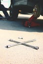 A wheel wrench lying on a ground close up view