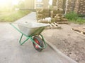 cart and behind rolls of turf lying on pallet in yard of multistory building. Concept of preparation for ennobling of urban Royalty Free Stock Photo