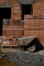 Wheelbarrow at the construction site of residential house building. Royalty Free Stock Photo