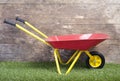 Wheelbarrow on frass against wooden wall