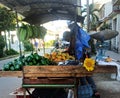 A wheelbarrow with fruits in Havana. Seller uses a sunflower to attract customers.