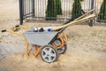 A wheelbarrow full of construction tools and equipment. Preparation for work. Moving loads at the construction site