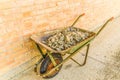 wheelbarrow full of rocks, stones and rubble