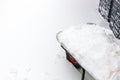 Wheelbarrow full of snow. Lots of snow on the sidewalk