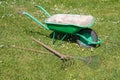 Wheelbarrow with lawn rake and claw cultivator Royalty Free Stock Photo