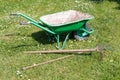 Wheelbarrow with lawn rake and claw cultivator