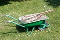 Wheelbarrow with lawn rake and claw cultivator