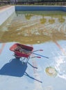 Wheelbarrow at pool bottom Royalty Free Stock Photo