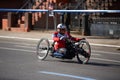 Wheelchair athlete racing at the NYC Marathon. Disabled athlete on wheelchair