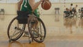 Wheelchair basketball player dribbling the ball quickly during training of disabled sportsmen