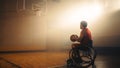 Wheelchair Basketball Player Wearing Red Uniform Holding Ball, Prepairing to Score a Perfect Goal. Royalty Free Stock Photo
