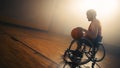 Wheelchair Basketball Player Wearing Red Uniform Leads Ball Successfully to Score a Perfect Goal. Royalty Free Stock Photo