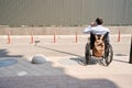 Wheelchair-bound man talking on mobile phone outside