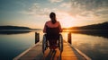 Wheelchair bound woman enjoying lakeside sunset Royalty Free Stock Photo