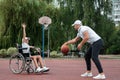 Wheelchair concept, disabled child, father and son, full life, paralyzed. A disabled son in a wheelchair plays with his father on