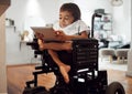 Wheelchair, disability and child with tablet for learning, video or games in home. Cerebral palsy, boy and disabled use Royalty Free Stock Photo