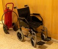 wheelchair and fire extinguisher Royalty Free Stock Photo