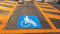 Wheelchair Handicap Sign on dark asphalt road street background- handicap parking place Royalty Free Stock Photo