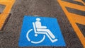 Wheelchair Handicap Sign on dark asphalt road street background- handicap parking place Royalty Free Stock Photo