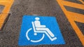 Wheelchair Handicap Sign on dark asphalt road street background- handicap parking place Royalty Free Stock Photo