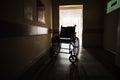 The wheelchair in the middle of an empty corridor in the hospital Royalty Free Stock Photo
