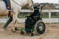 Wheelchair parked while a child has an equine therapy session. Royalty Free Stock Photo