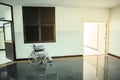 Wheelchair for patients stand by in the common hall corridor area next to exit door. Royalty Free Stock Photo