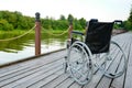 Wheelchair on the river bank Royalty Free Stock Photo