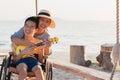 Wheelchair on the sea beach go to travel on holiday concept. Royalty Free Stock Photo