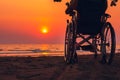 Wheelchair on the sea beach with sunset on travel time in holiday family and learning about nature around the sea Royalty Free Stock Photo