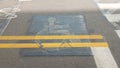 Wheelchair sign with yellow lines painted over