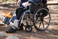 Man in a wheelchair in a park near the fire.