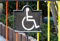 Wheelchair symbol attached to a colourful fence