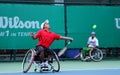 A wheelchair tennis player during a tennis championship match, t