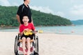 Wheelchair travel on the sea beach and playing the music. Royalty Free Stock Photo