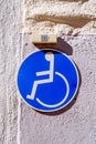 Wheelchair user sign and ring above it.