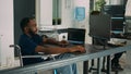 Wheelchair user software engineer working on server program with computer Royalty Free Stock Photo