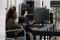 Wheelchair user typing script code on computer Royalty Free Stock Photo