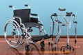 Wheelchair, walking frame and crutches on the wooden floor in th