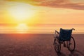 Wheelchairs parked on the beach at sunset time, in a lonely atmosphere