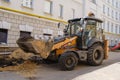 Wheeled compact excavator loader Case is working on the repair of urban communications