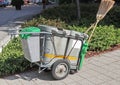 Wheeled garbage can with broom on the street Royalty Free Stock Photo